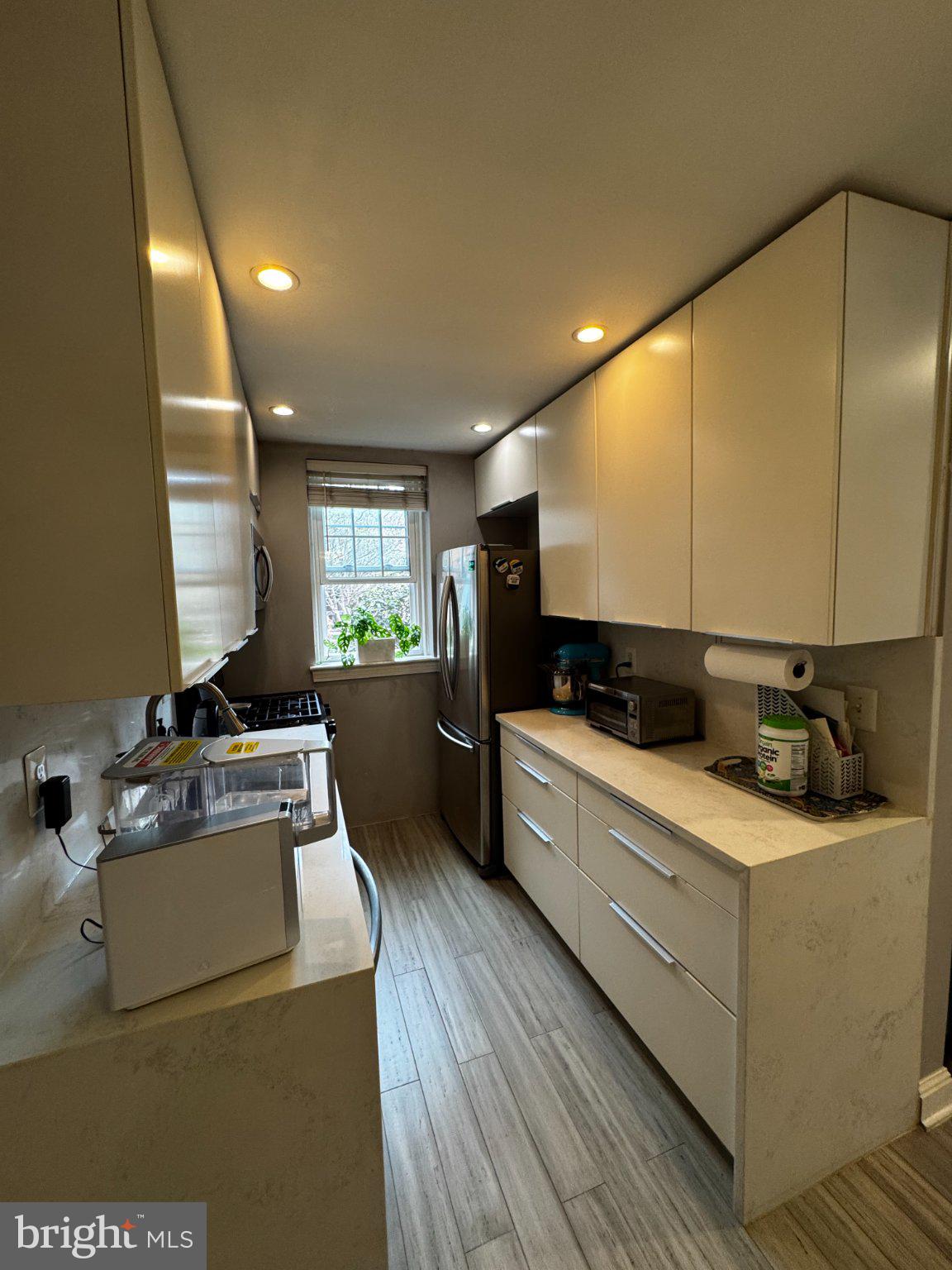 24 South Old Glebe Road, Unit 101 Arlington, VA 22204 - Photo 15 of 19 Sleek modern kitchen with natural light.