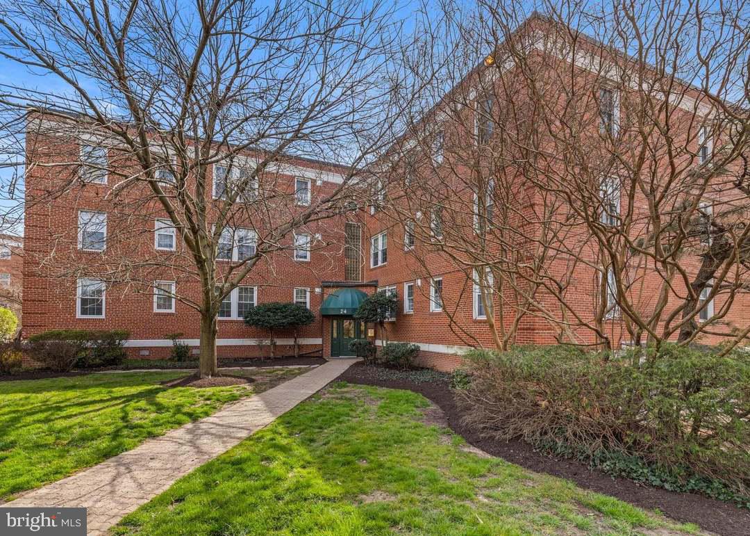 24 South Old Glebe Road, Unit 101 Arlington, VA 22204 - Photo 2 of 19 Charming brick residence with lush greenery.