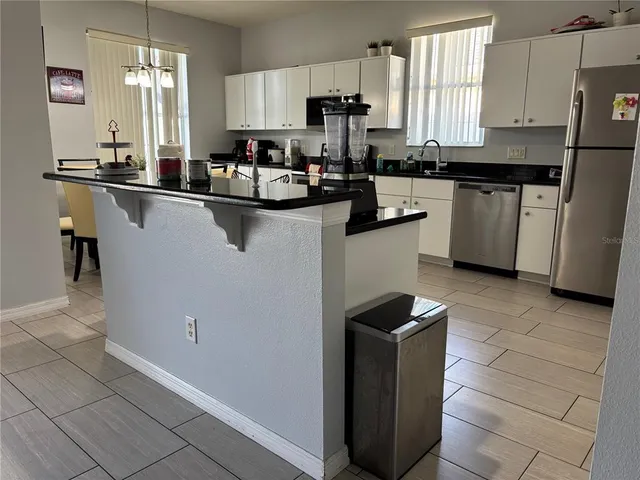 a view of a dining room with furniture and chandelier