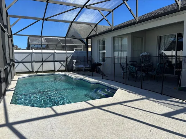 a view of a backyard with sitting area