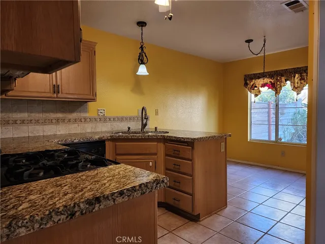 a kitchen with a cabinets and window