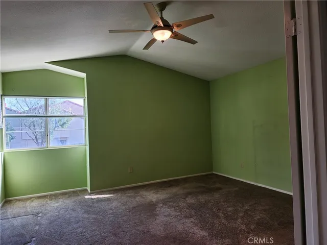 a view of empty room with fan and window