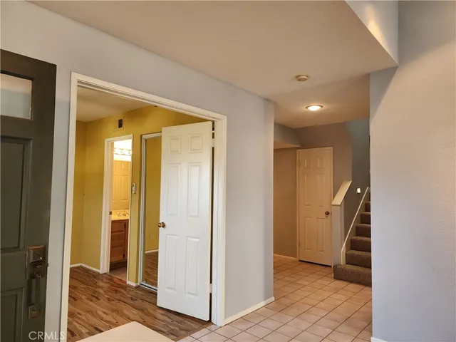 a view of a hallway with closet and wooden floor
