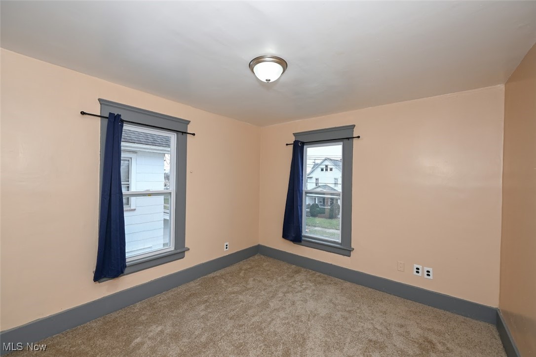 667 Elma Street Akron, OH 44310 - Photo 34 of 42 Spare room featuring baseboards and carpet