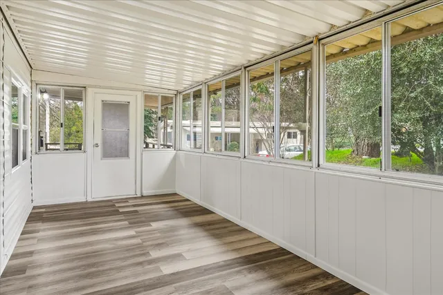 a bathroom with a granite countertop sink vanity mirror and toilet