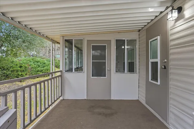 a view of a porch with wooden floor and stairs