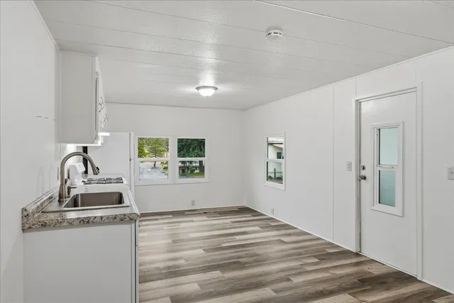 a kitchen with white cabinets and white appliances