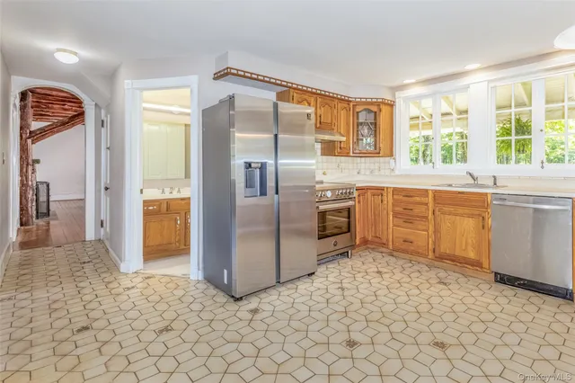 a kitchen with stainless steel appliances granite countertop a refrigerator and a sink