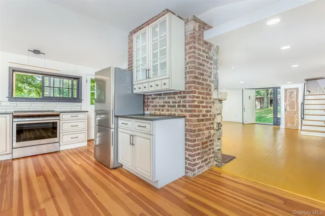 a kitchen with a sink cabinets and a fireplace