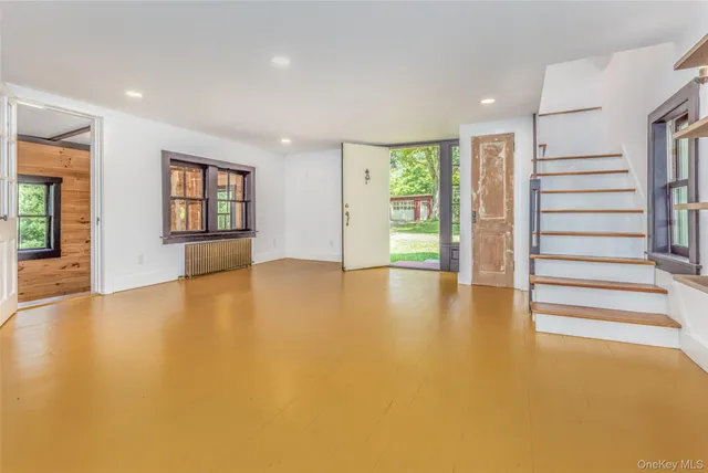 wooden floor in an empty room with a window