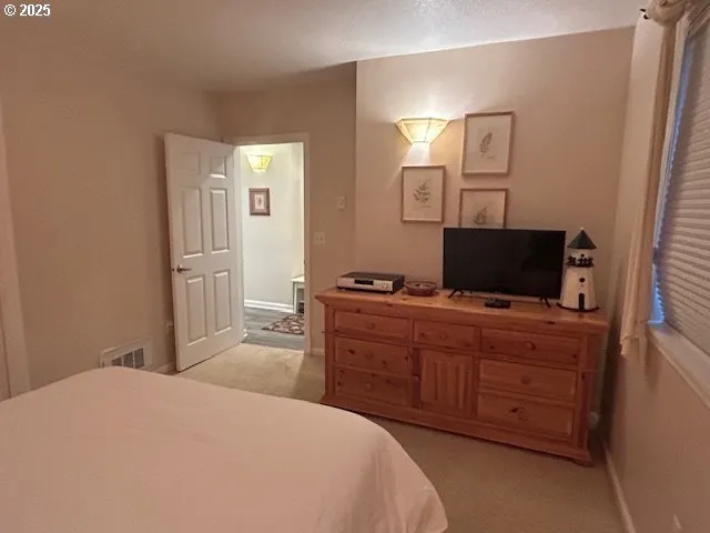 a kitchen that has a refrigerator a stove a sink a dining table and chairs