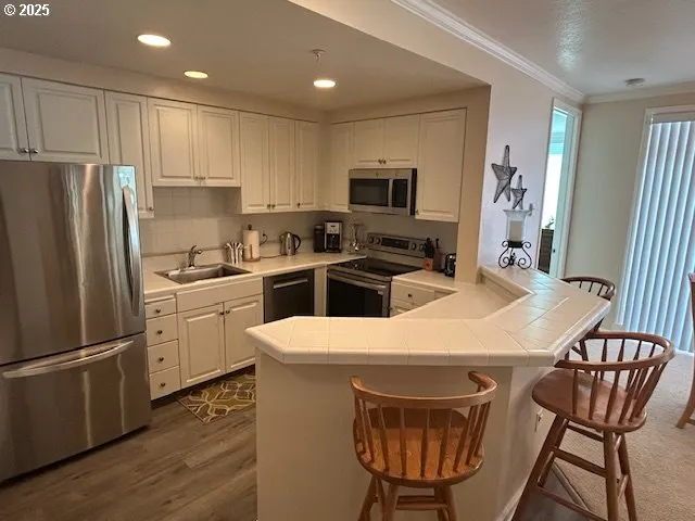 a bathroom with a sink a toilet a shower curtain and a large mirror