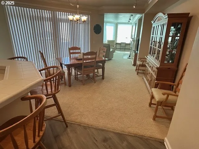 a view of a dining room with furniture and a chandelier