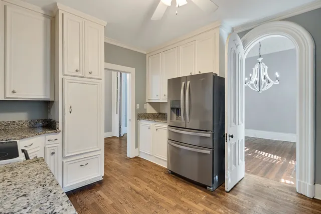 a kitchen with a refrigerator and a stove top oven