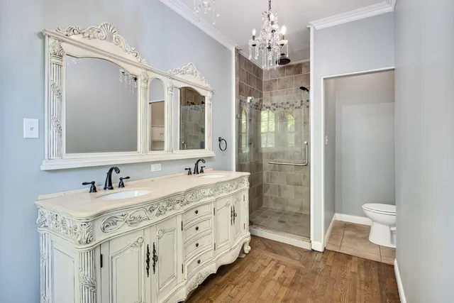 a bathroom with a double vanity sink mirror and shower