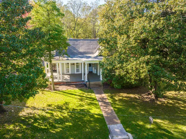 a view of a house with swimming pool and sitting area