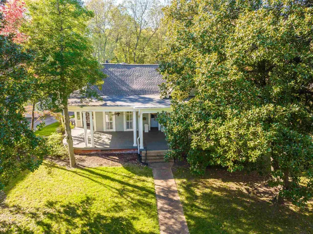 a view of house with swimming pool