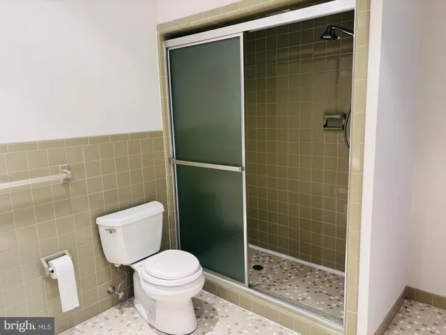 a white toilet sitting next to a bathroom sink