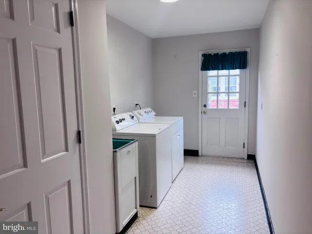 a utility room with closet dryer and washer