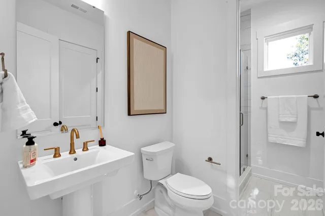 a white toilet sitting next to a bathroom sink