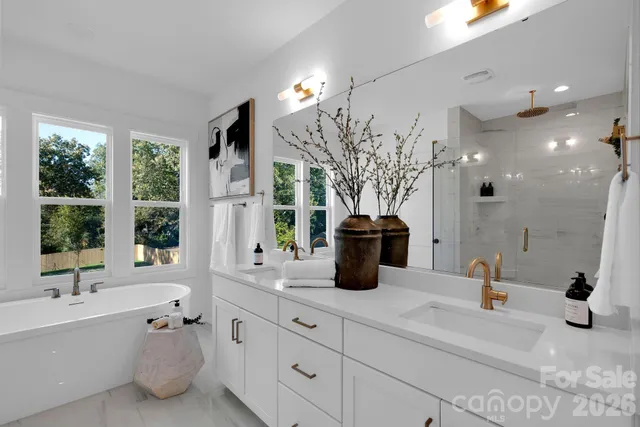 a bathroom with a tub sink and mirror
