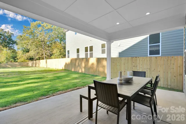 a view of a patio with a table and chairs