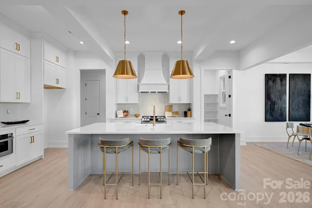 a kitchen with kitchen island stainless steel appliances a sink and a center island