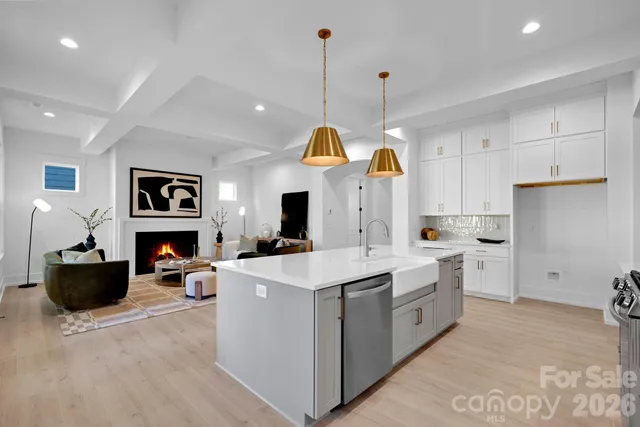 a large kitchen with stainless steel appliances granite countertop a stove and cabinets