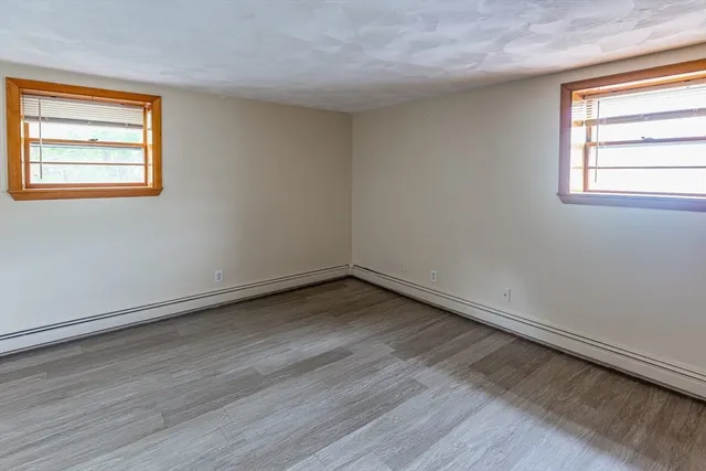 a kitchen with a refrigerator a stove a sink cabinets and wooden floor