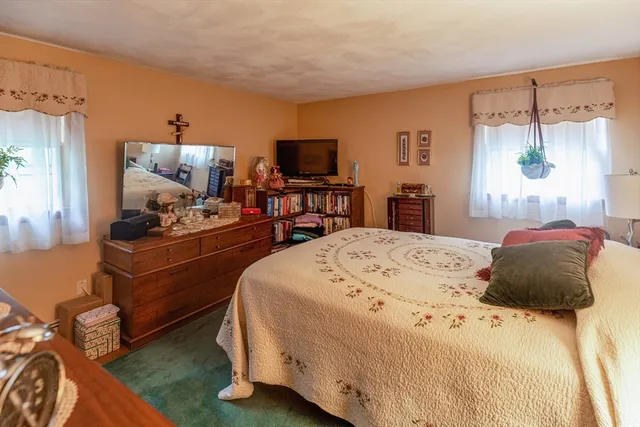 a bathroom with a granite countertop sink toilet and a mirror