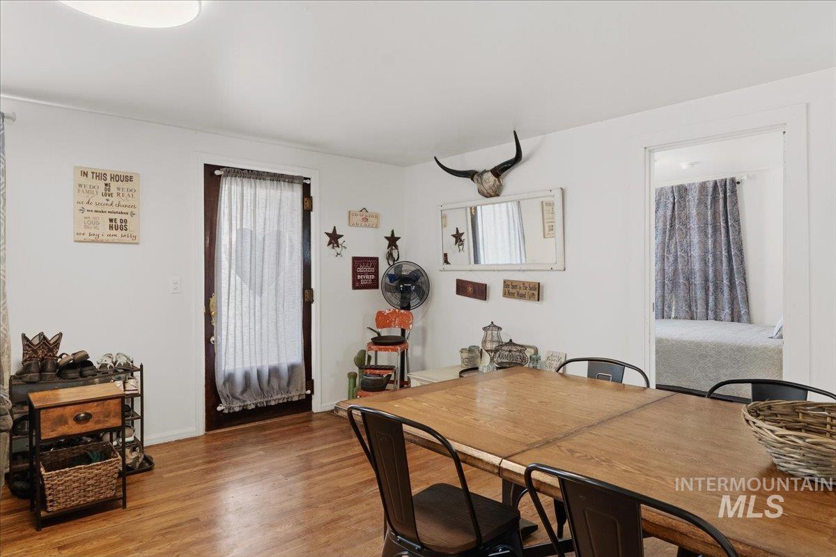 1958 East 1775 South Gooding, ID 83330 - Photo 13 of 49 Dining area featuring wood-finish flooring, white walls, and a light fixture