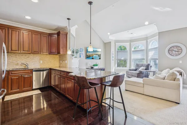 a kitchen with a table chairs stove and wooden floor