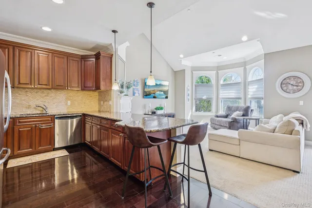 a kitchen with a table chairs stove and wooden floor