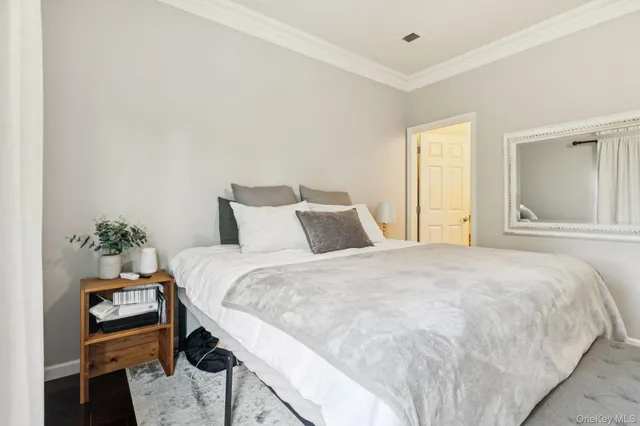 a bedroom with a bed and a potted plant