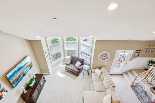 a living room with furniture and a floor to ceiling window