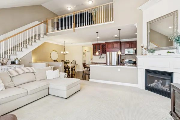 a living room with fireplace furniture and a flat screen tv