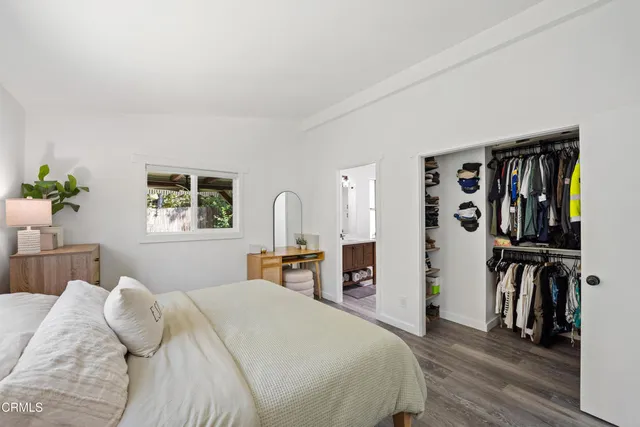 a bedroom with a bed and a book shelf