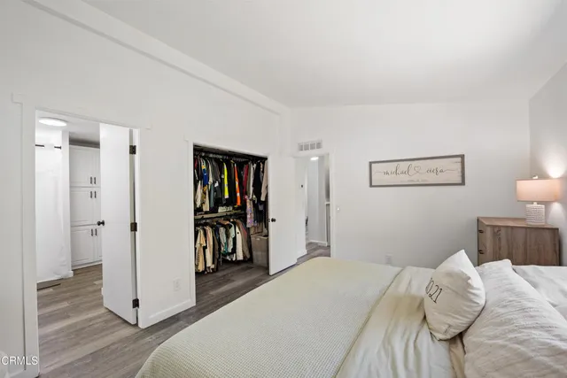 a bathroom with a granite countertop sink a toilet and a mirror