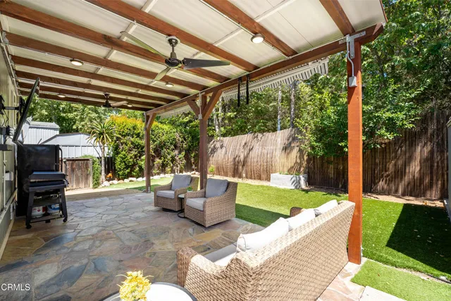 a backyard of a house with table and chairs