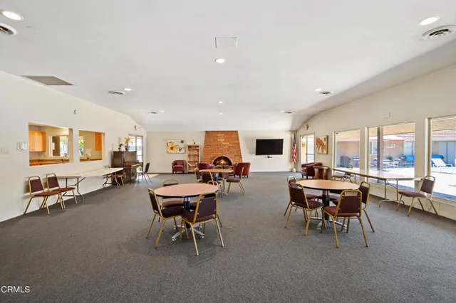 a room with pool table and windows