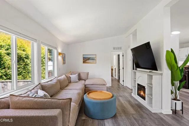 a kitchen with granite countertop a stove a sink and a refrigerator