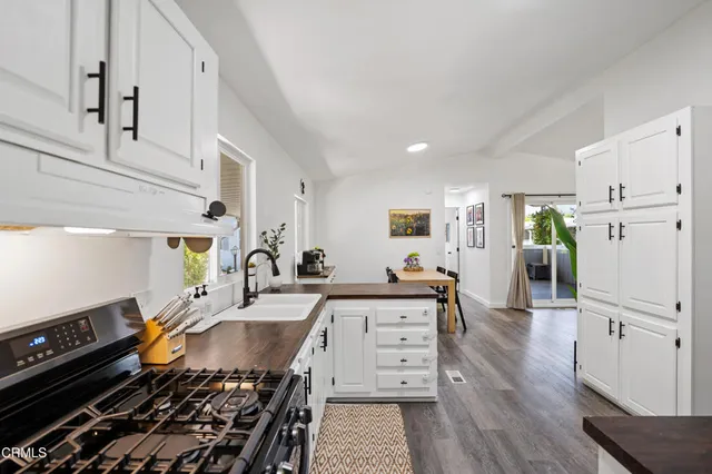 a kitchen with stainless steel appliances granite countertop a refrigerator and a stove