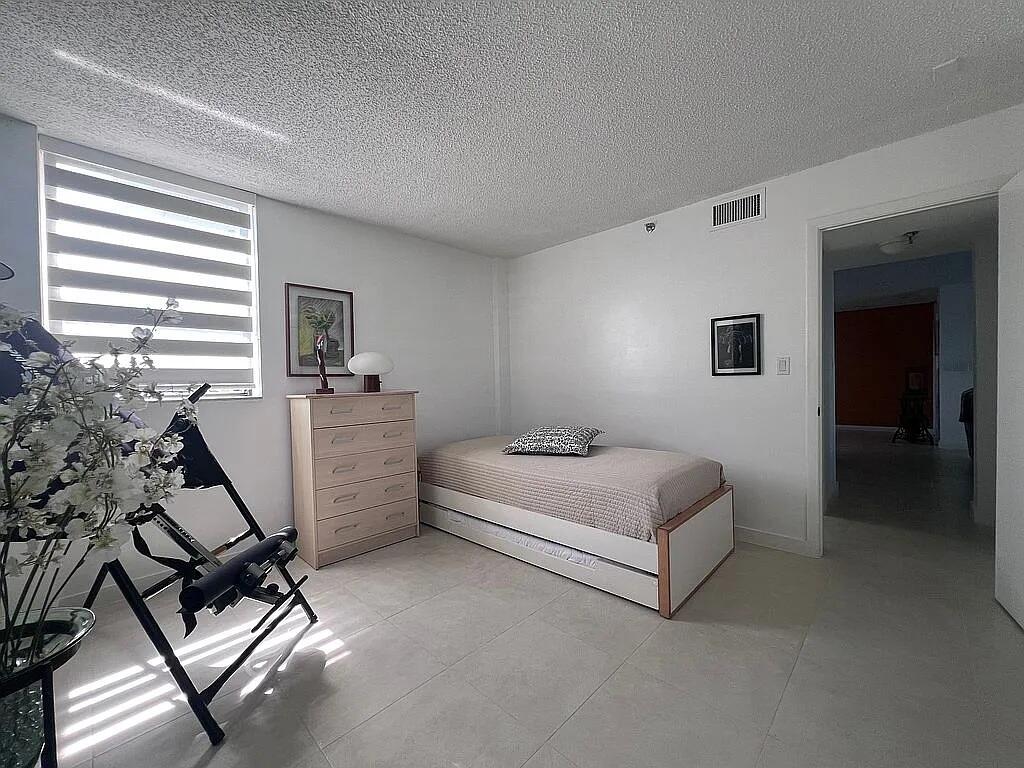 6463 La Costa Drive, Unit 105 Boca Raton, FL 33433 - Photo 22 of 40 a bedroom with furniture and a window