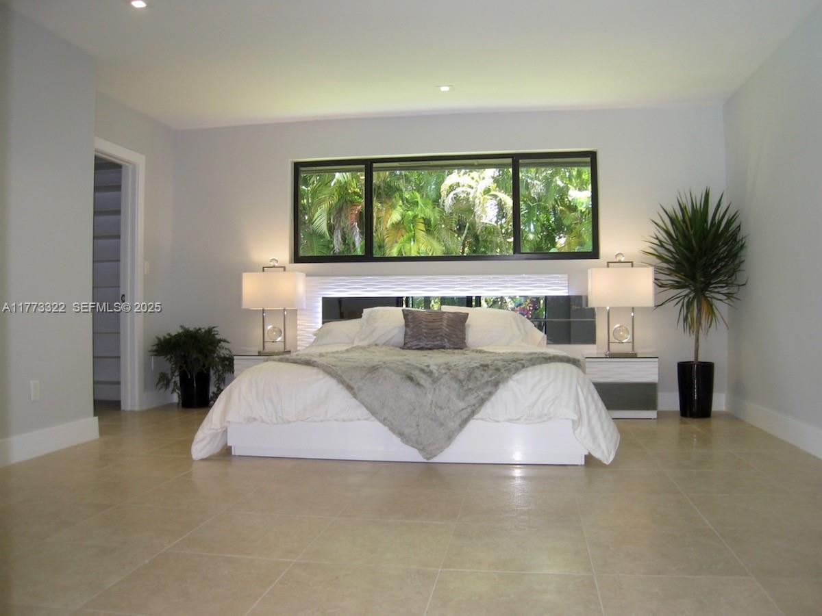 7125 Southwest 120th Street Pinecrest, FL 33156 - Photo 11 of 27 a living room with a couch and a large window