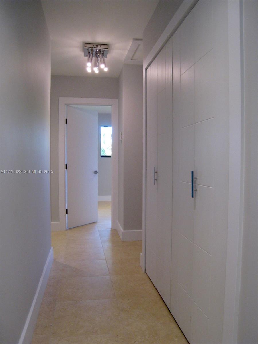 7125 Southwest 120th Street Pinecrest, FL 33156 - Photo 17 of 27 an empty room with fan and entrance