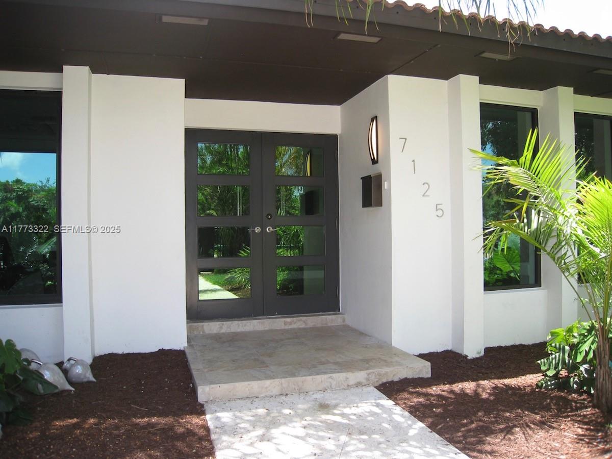 7125 Southwest 120th Street Pinecrest, FL 33156 - Photo 2 of 27 a view of a entryway door of the house