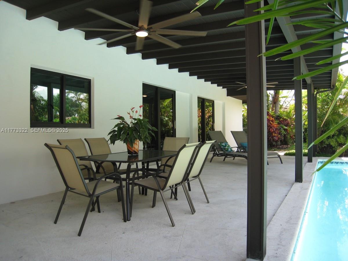 7125 Southwest 120th Street Pinecrest, FL 33156 - Photo 22 of 27 a dining room with furniture and window