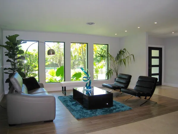 a living room with furniture and a large window