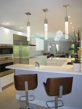 a room with table chairs and kitchen view