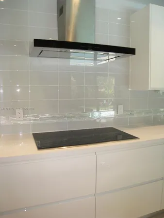 a kitchen with stainless steel appliances kitchen island a large window in it and kitchen island
